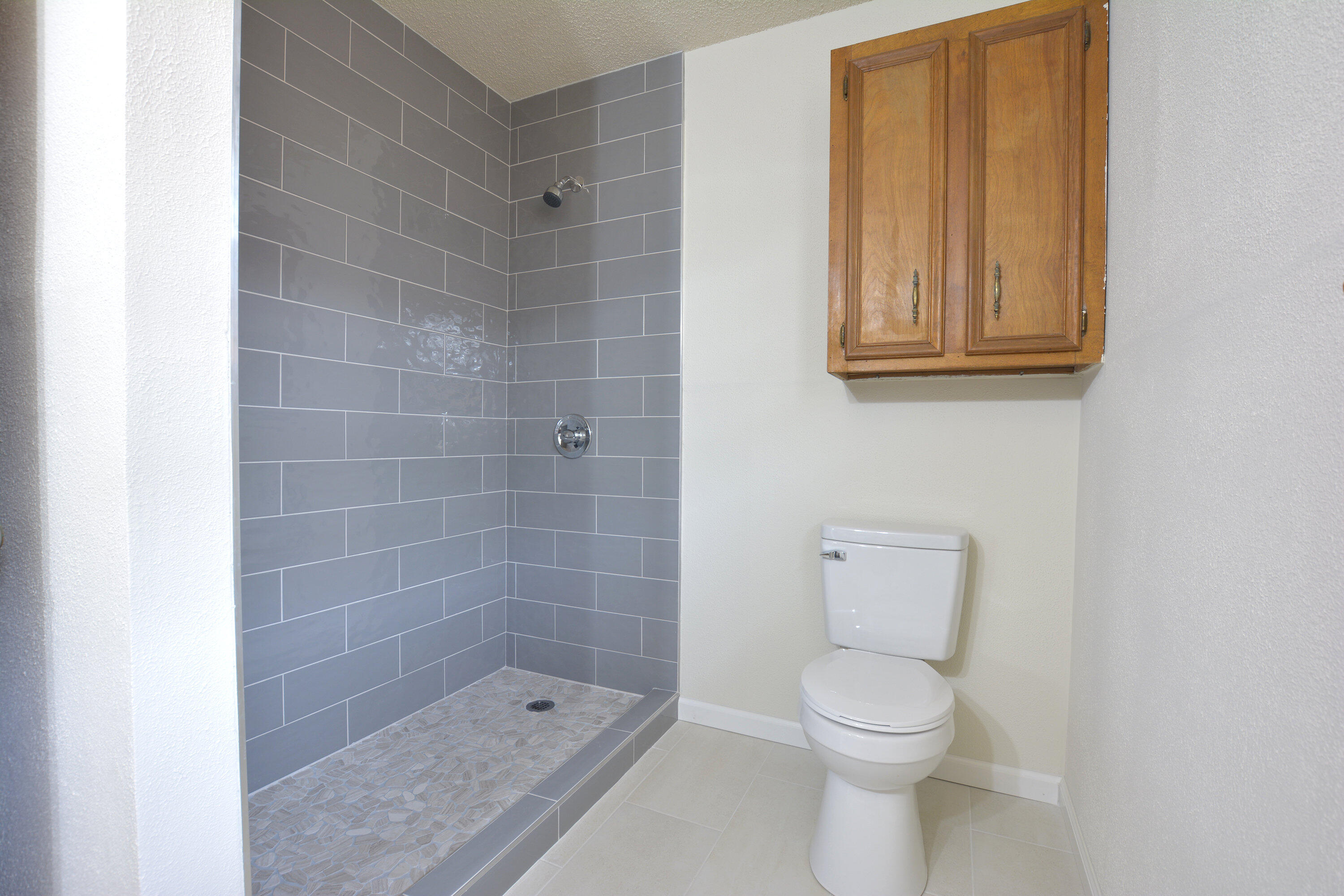 5224 9th Street Lubbock, TX 79416 - Photo 18 of 26 a bathroom with a toilet and a shower