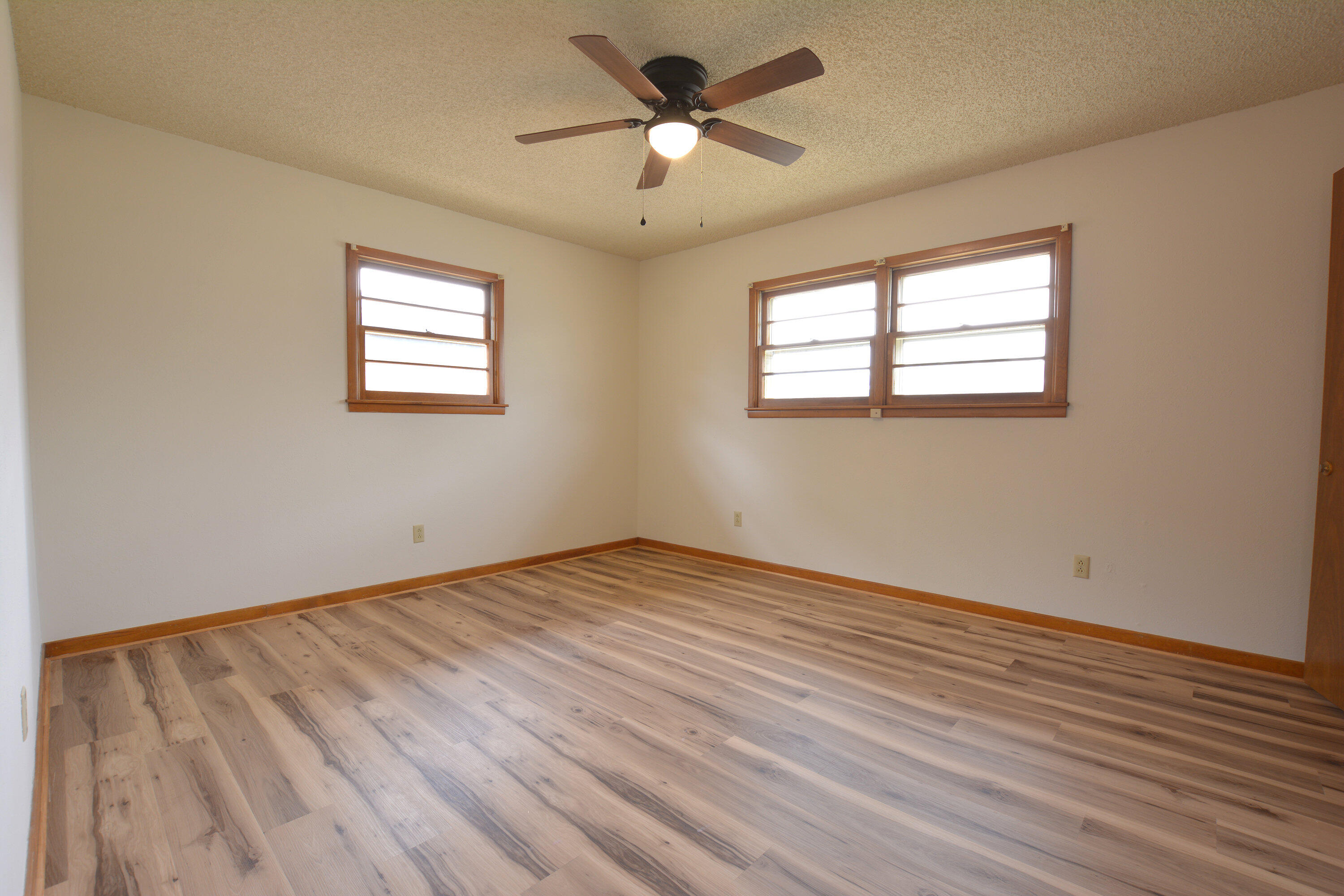 5224 9th Street Lubbock, TX 79416 - Photo 20 of 26 a view of empty room with wooden floor and fan