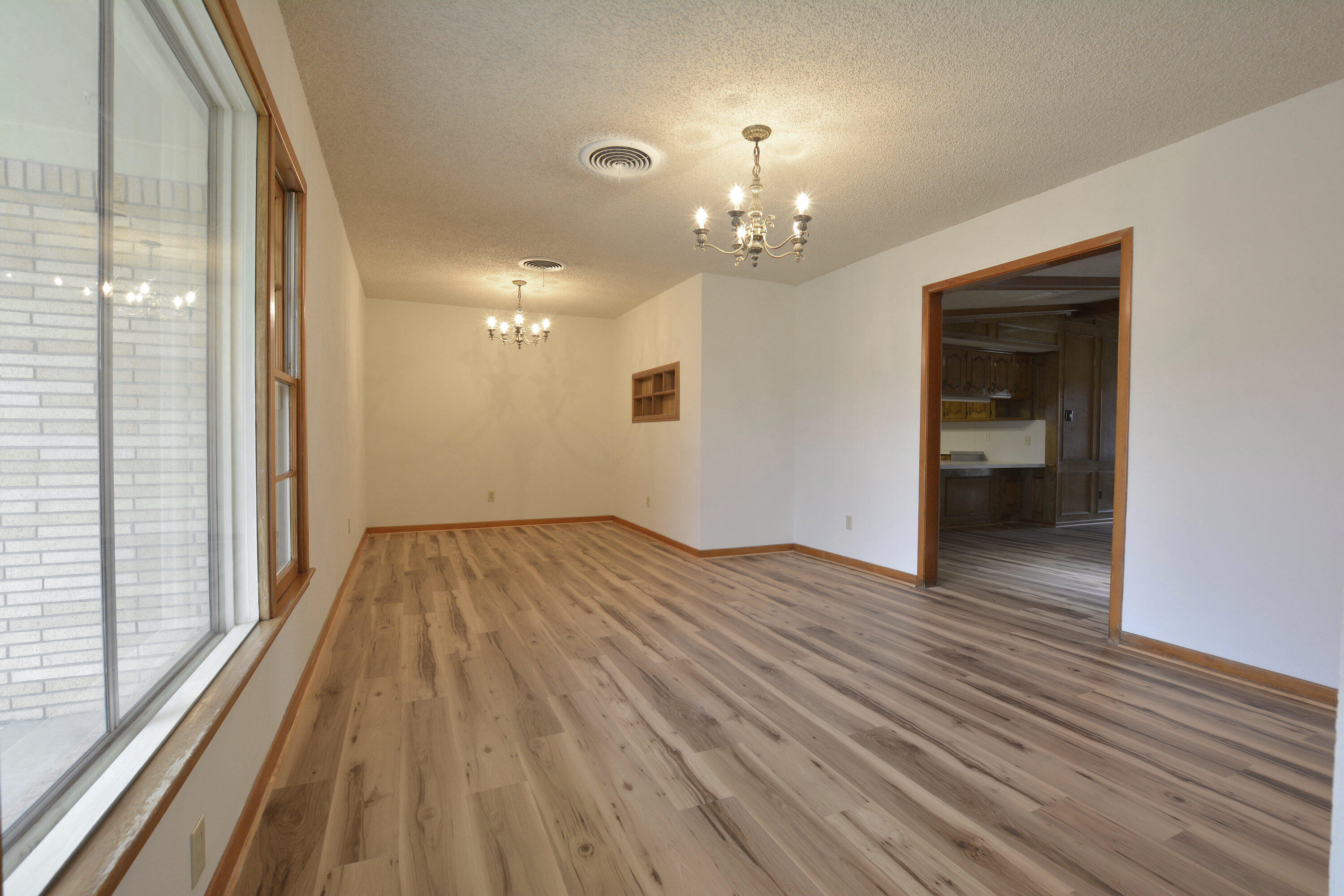 5224 9th Street Lubbock, TX 79416 - Photo 4 of 26 a view of empty room with wooden floor and fan