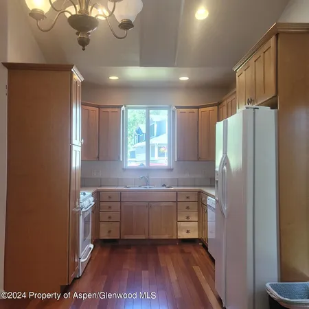 a kitchen with stainless steel appliances a refrigerator and a sink