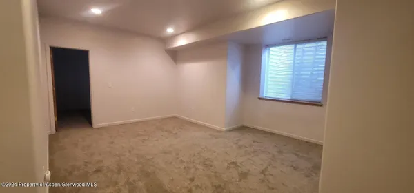 an empty room with windows and closet