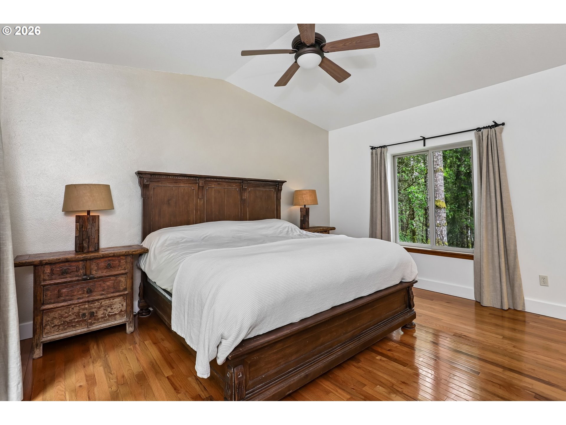 873 Mountain View Road Kalama, WA 98625 - Photo 22 of 45 a bedroom with a bed a dresser and a large window