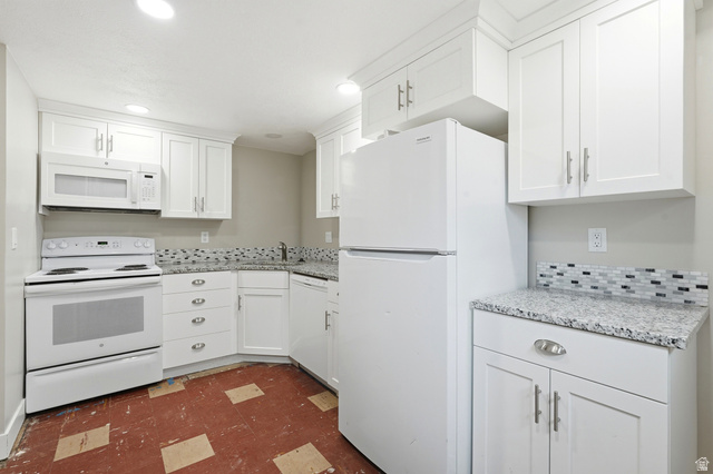 778 East 200 North Logan, UT 84321 - Photo 13 of 43 Kitchen featuring white shaker cabinetry, speckled countertops, a mosaic tile backsplash, and recessed lighting
