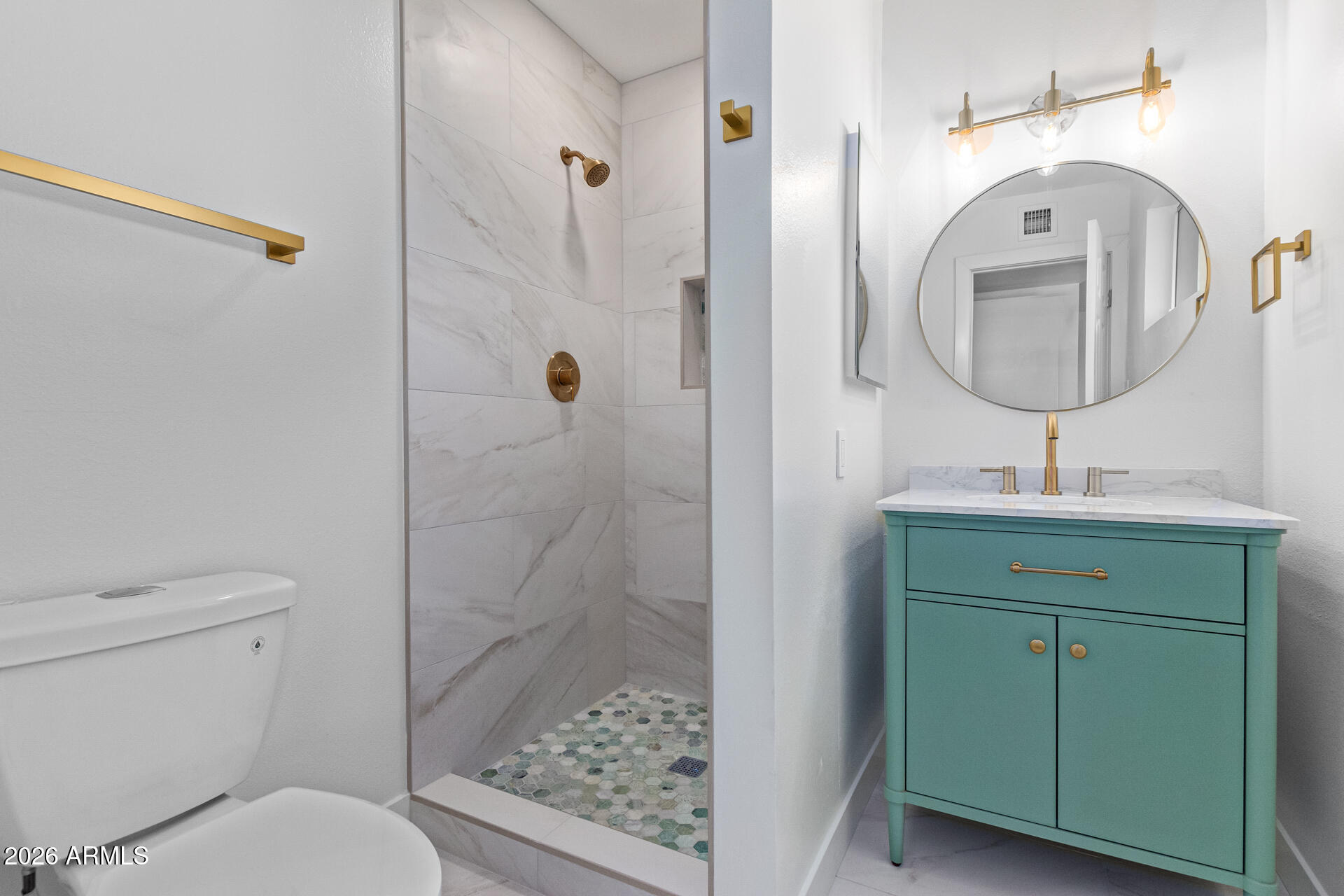 2111 South River Drive Tempe, AZ 85282 - Photo 11 of 26 a bathroom with a toilet a sink and shower