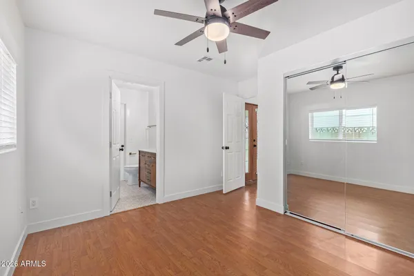 an empty room with fan and entrance