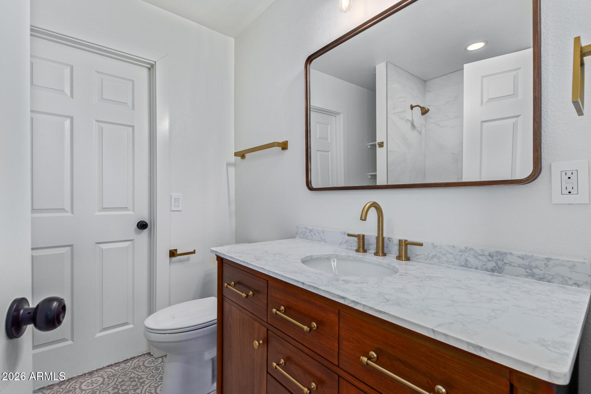 2111 South River Drive Tempe, AZ 85282 - Photo 13 of 26 a bathroom with a granite countertop sink and a toilet