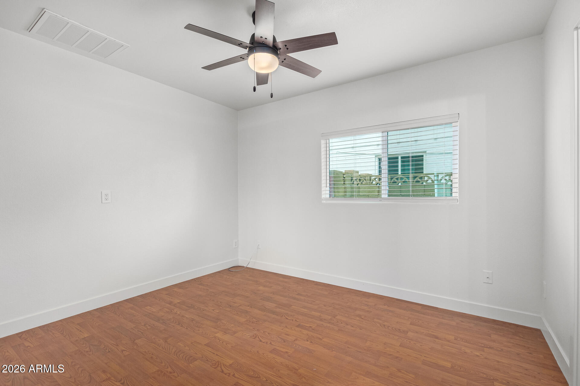 2111 South River Drive Tempe, AZ 85282 - Photo 18 of 26 an empty room with a window and a fan