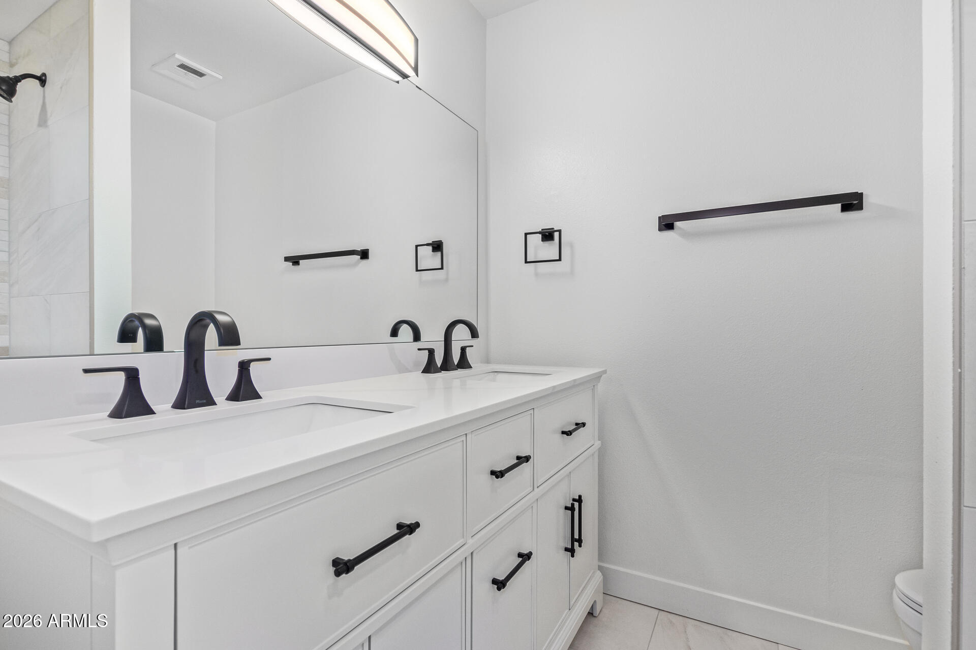 2111 South River Drive Tempe, AZ 85282 - Photo 19 of 26 a bathroom with a sink and a mirror