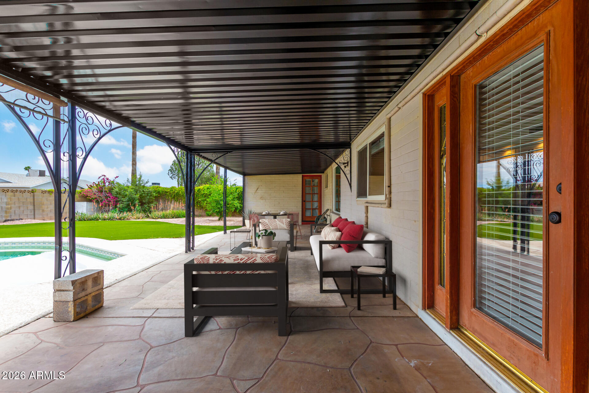 2111 South River Drive Tempe, AZ 85282 - Photo 21 of 26 a view of a patio with a table chairs and a backyard