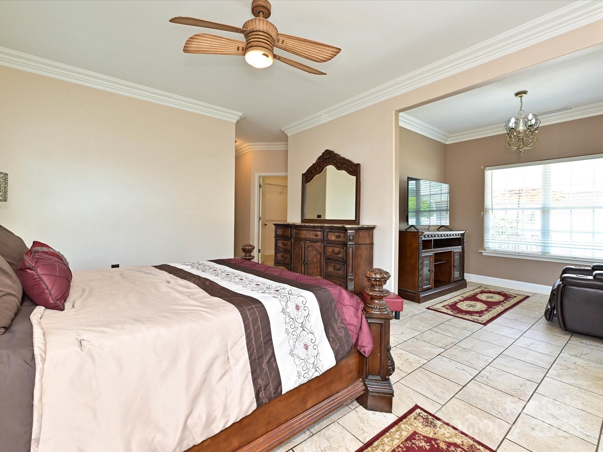 4562 Lanstone Court Southwest Concord, NC 28027 - Photo 12 of 30 a bedroom with a bed a ceiling fan and a flat tv screen