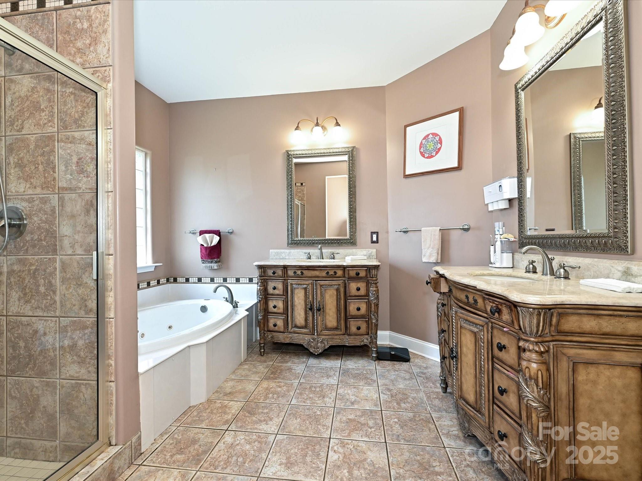 4562 Lanstone Court Southwest Concord, NC 28027 - Photo 13 of 30 a spacious bathroom with a double vanity sink mirror and bathtub
