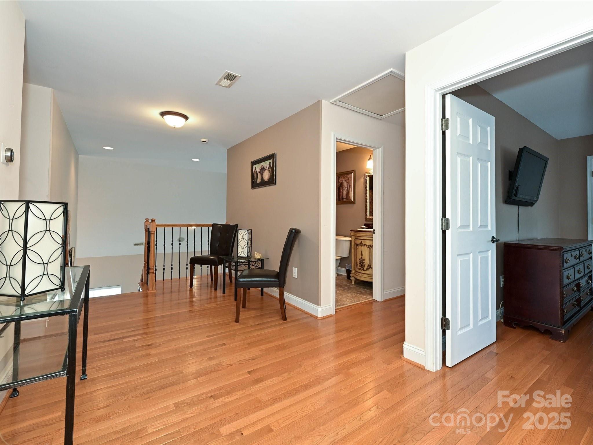 4562 Lanstone Court Southwest Concord, NC 28027 - Photo 19 of 30 a view of a livingroom with furniture and a flat screen tv
