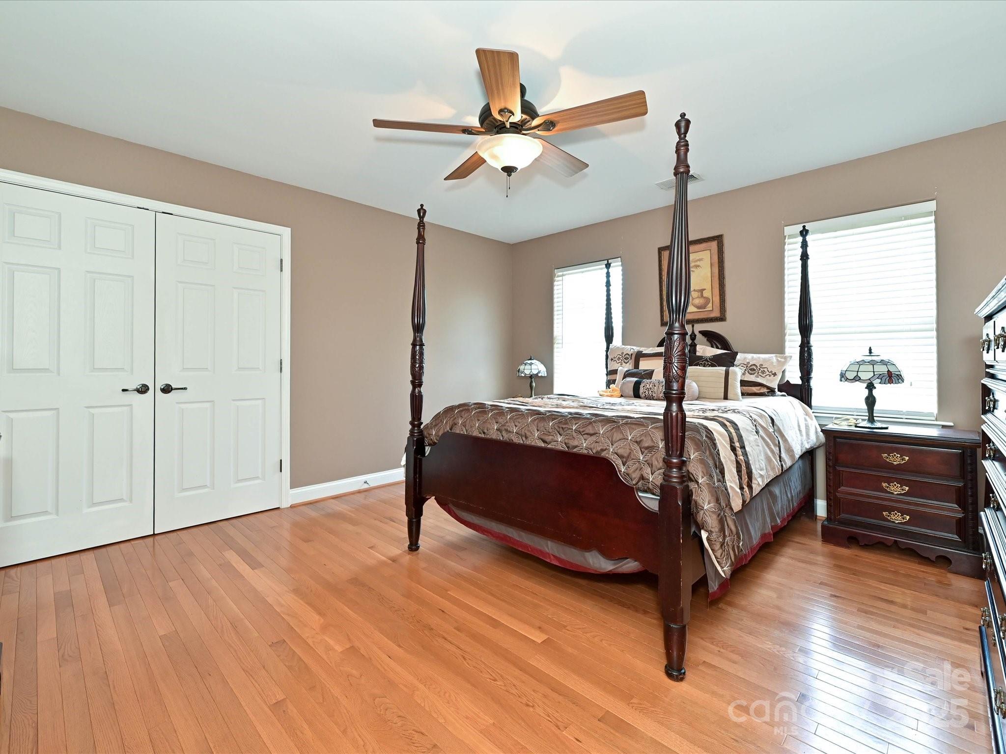 4562 Lanstone Court Southwest Concord, NC 28027 - Photo 20 of 30 a bed room with a bed and a ceiling fan