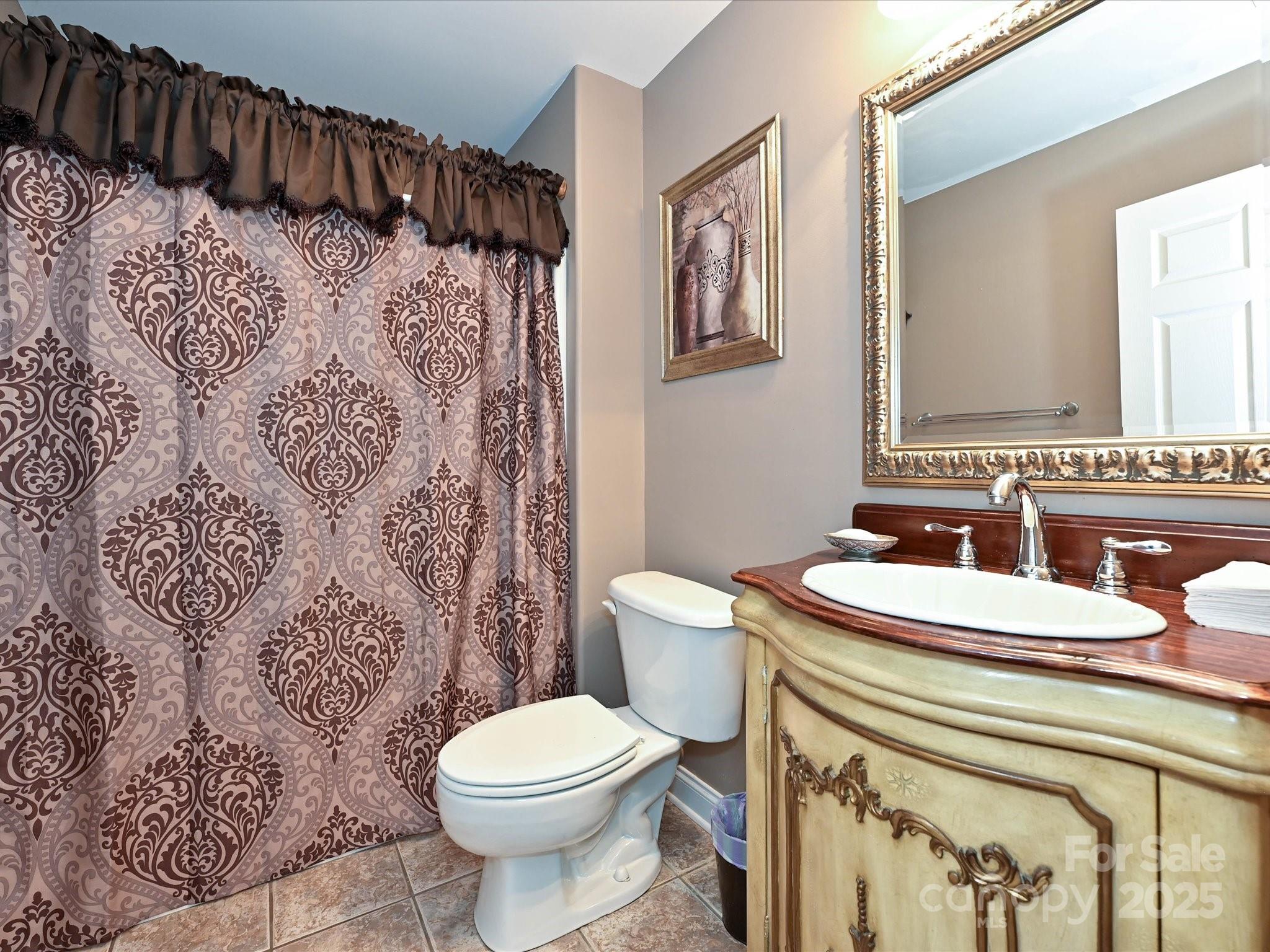 4562 Lanstone Court Southwest Concord, NC 28027 - Photo 23 of 30 a bathroom with a sink toilet and shower