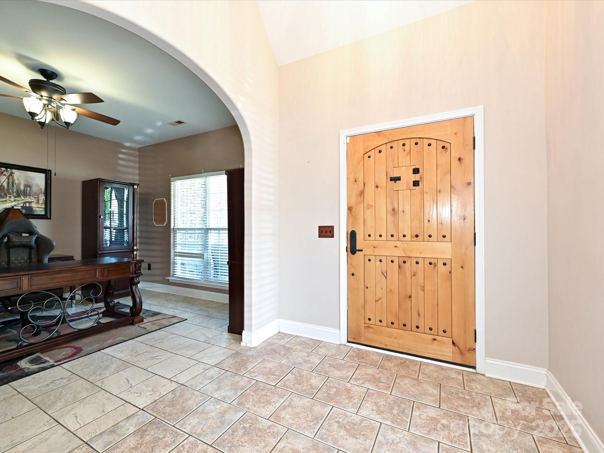 4562 Lanstone Court Southwest Concord, NC 28027 - Photo 4 of 30 a view of a livingroom with a hardwood floor and a dining table