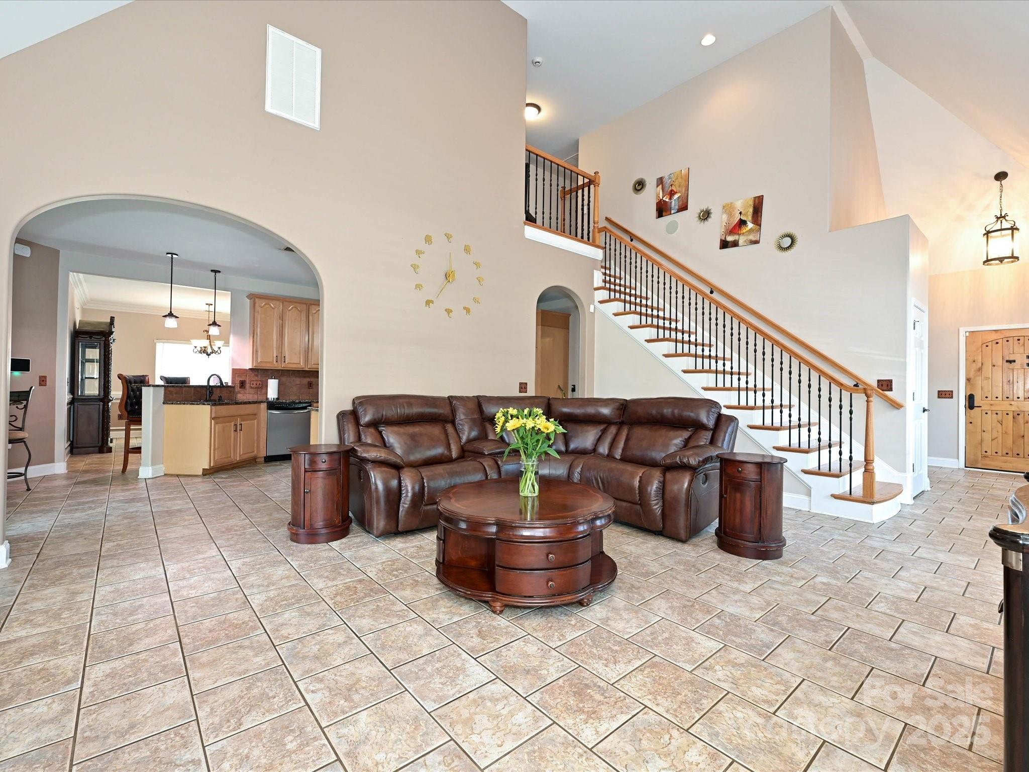 4562 Lanstone Court Southwest Concord, NC 28027 - Photo 7 of 30 a living room with furniture and a dining table