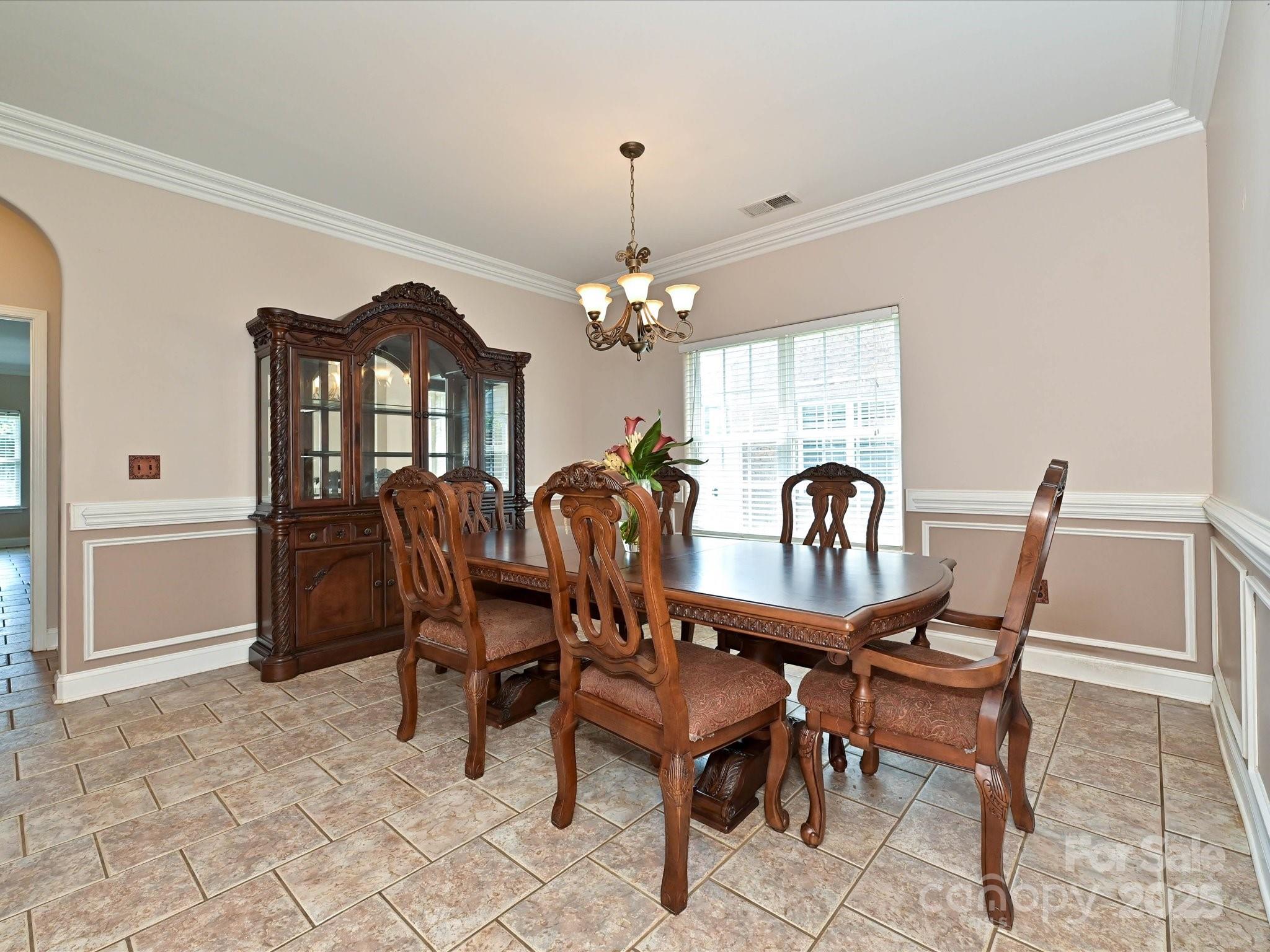 4562 Lanstone Court Southwest Concord, NC 28027 - Photo 10 of 30 a view of a dining room with furniture and chandelier