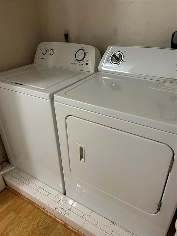 3936 Southwest 26th Terrace, Unit B Gainesville, FL 32608 - Photo 13 of 15 a utility room with dryer and washer