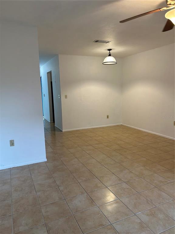 3936 Southwest 26th Terrace, Unit B Gainesville, FL 32608 - Photo 2 of 15 an empty room with an entryway and fan