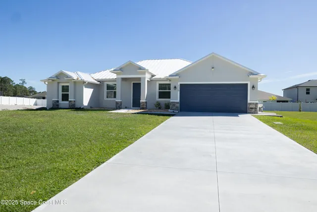 a front view of house with yard and green space