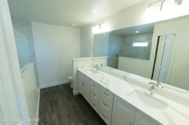 a bathroom with a double vanity sink and mirror