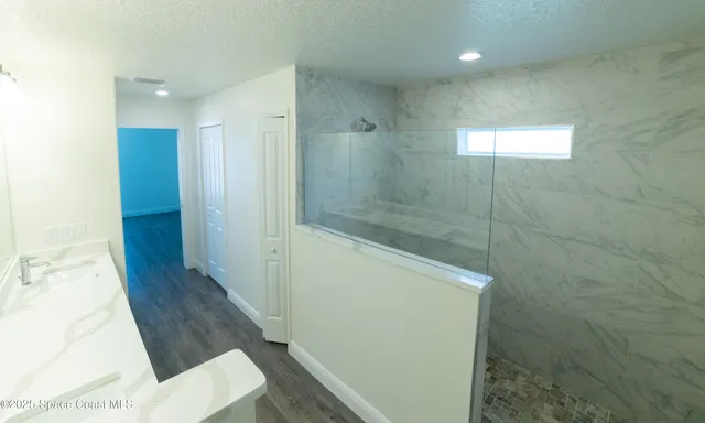 a bathroom with a shower and a mirror