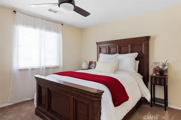 a bedroom with a bed and window