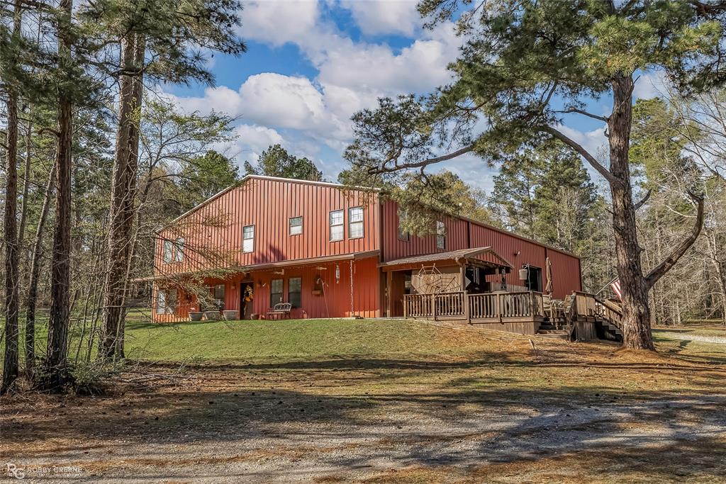 6340 Pine Hill Road Shreveport, LA 71107 - Photo 11 of 40 View of front of house featuring a front yard and a wooden deck