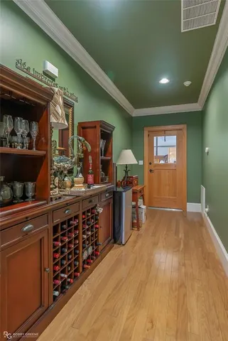 a living room with stainless steel appliances kitchen island granite countertop a sink and cabinets