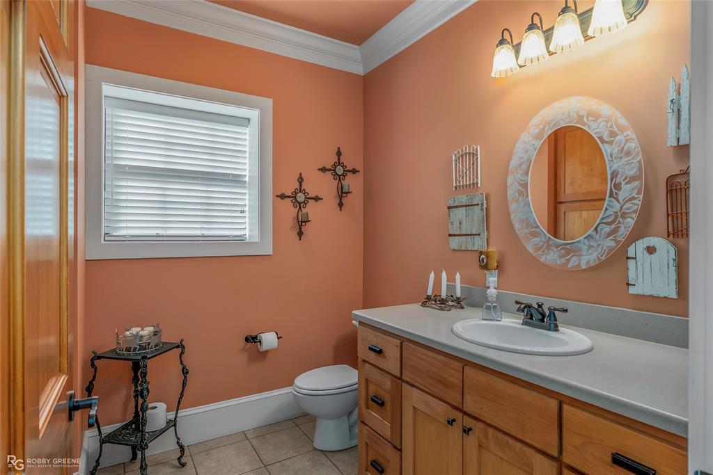 6340 Pine Hill Road Shreveport, LA 71107 - Photo 20 of 40 Half bathroom featuring light tile patterned floors, vanity, and ornamental molding