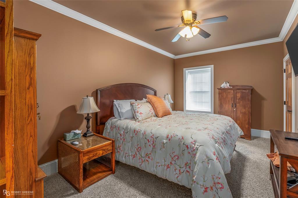 6340 Pine Hill Road Shreveport, LA 71107 - Photo 24 of 40 Bedroom featuring crown molding, carpet, and a ceiling fan