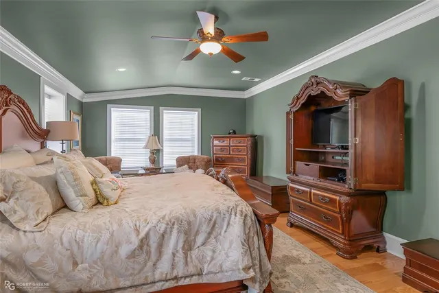 a bedroom with a bed couch and window