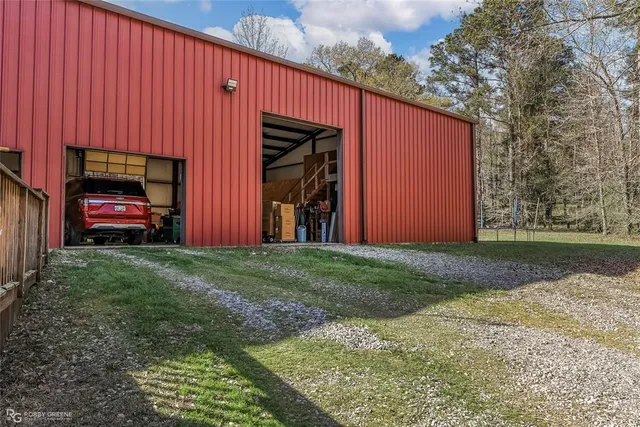 a front view of a house with a garden and trees