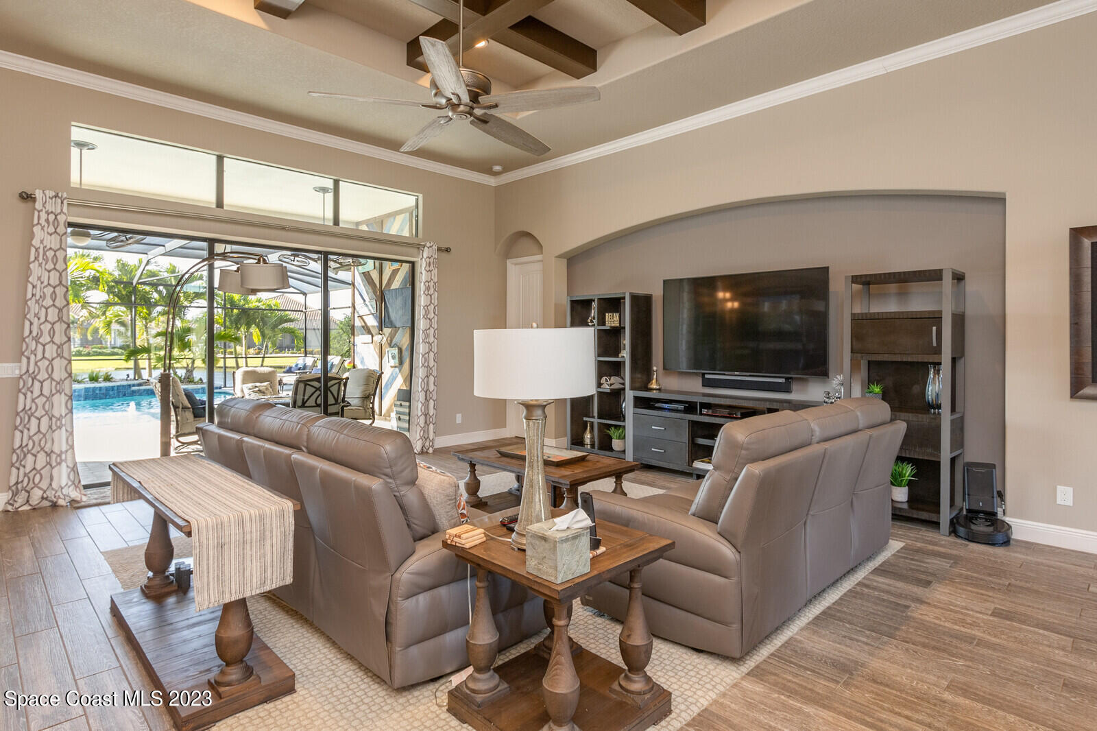 5107 Kirkwall Circle Melbourne, FL 32940 - Photo 18 of 44 a living room with furniture a flat screen tv and a large window