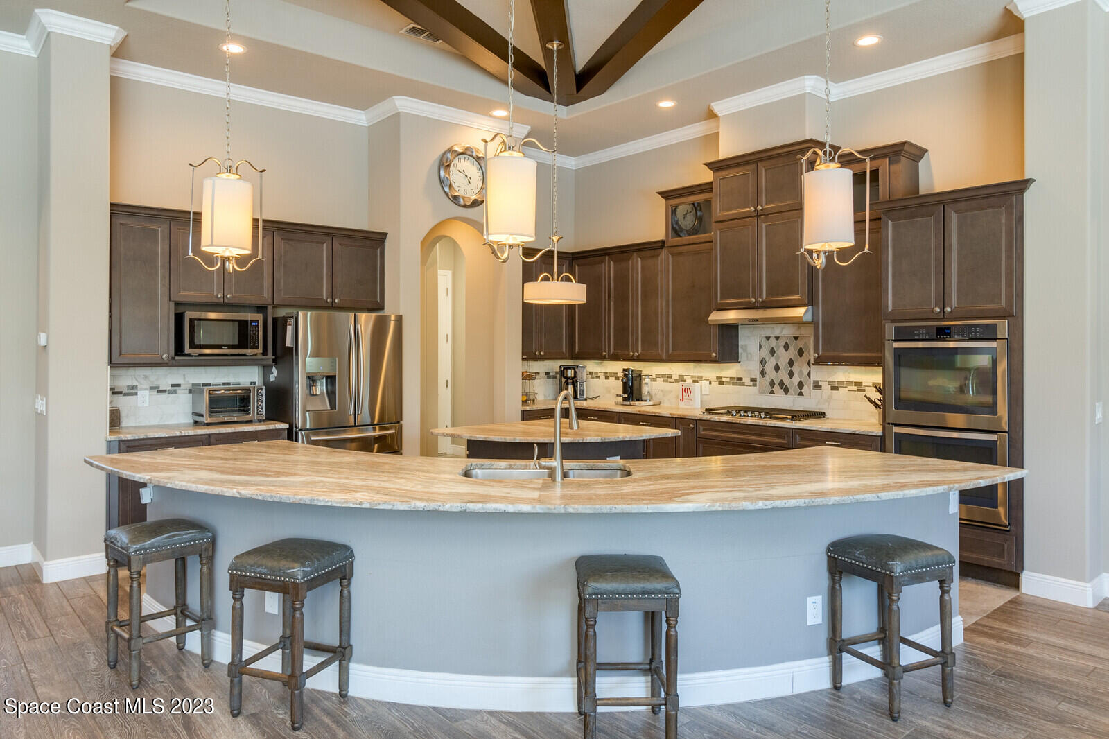 5107 Kirkwall Circle Melbourne, FL 32940 - Photo 22 of 44 a kitchen with stainless steel appliances granite countertop a table chairs sink and cabinets