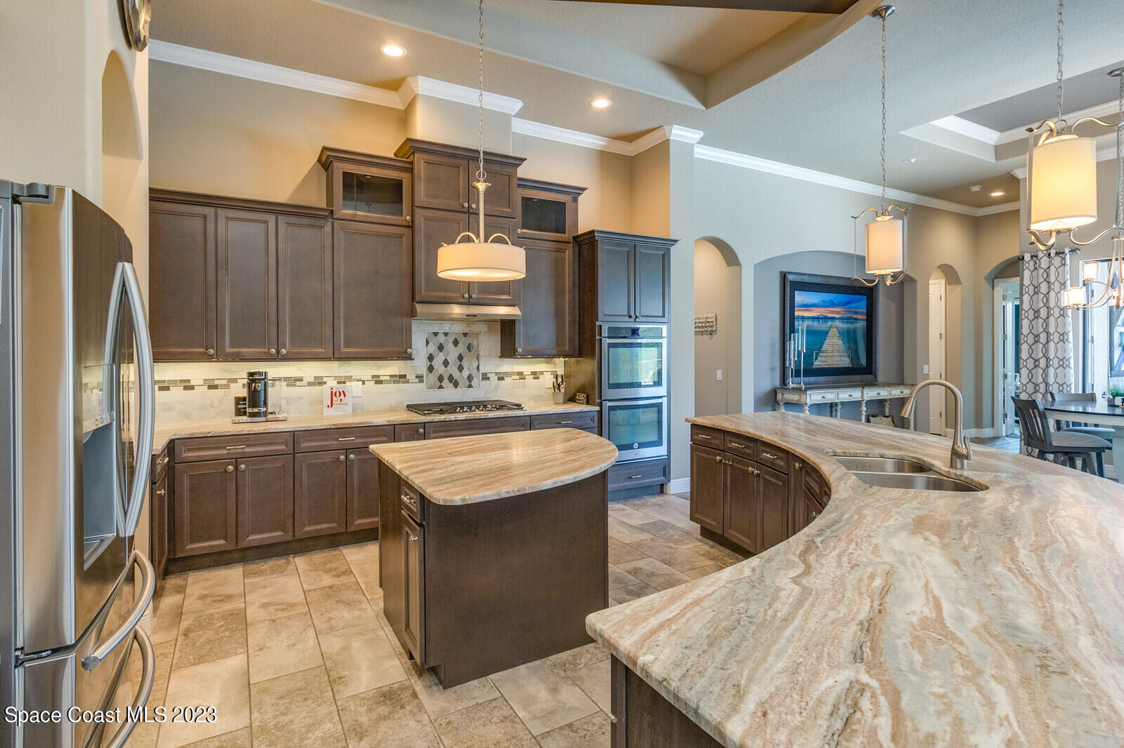 5107 Kirkwall Circle Melbourne, FL 32940 - Photo 23 of 44 a kitchen with stainless steel appliances kitchen island granite countertop a sink refrigerator and cabinets