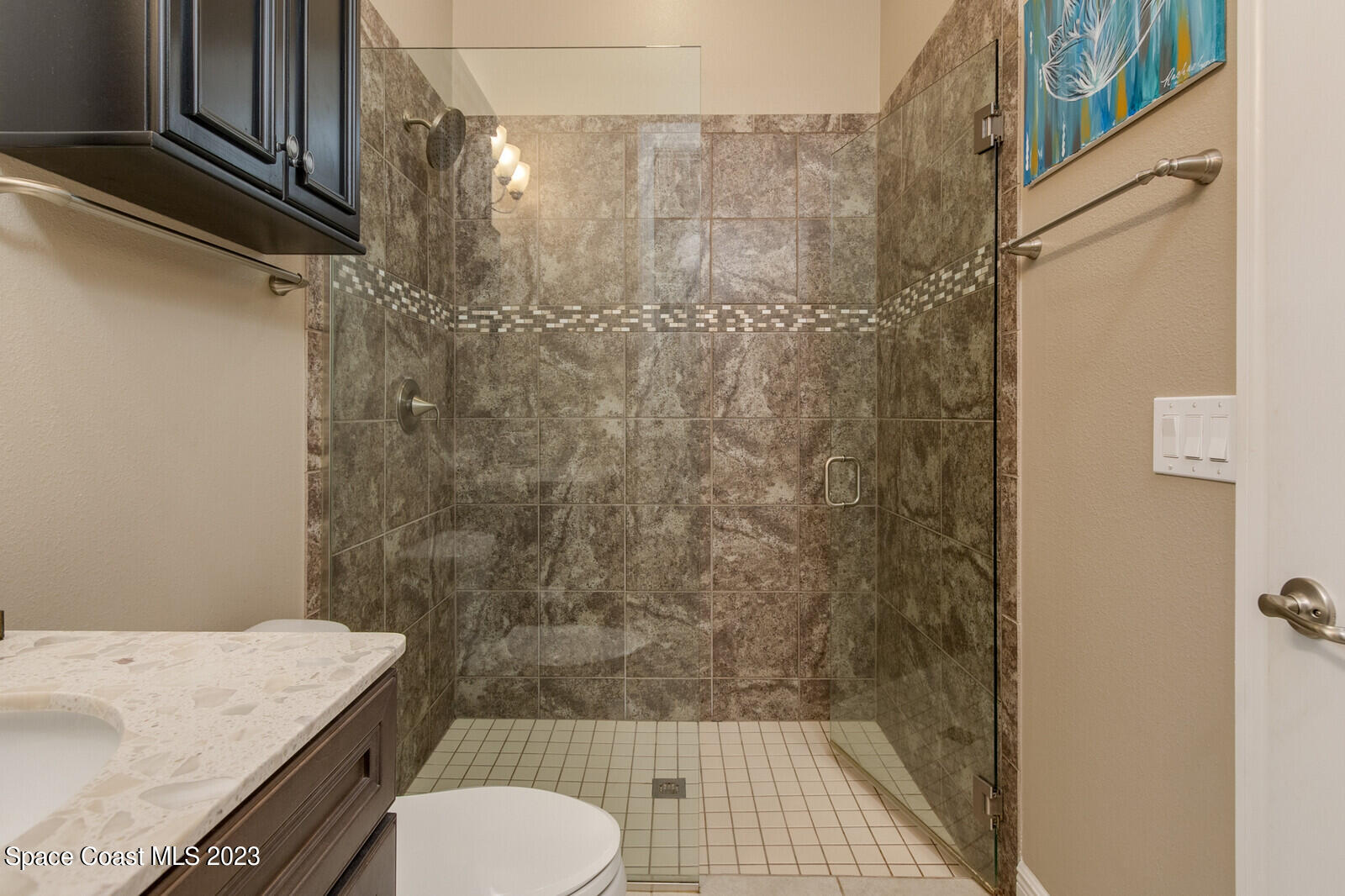 5107 Kirkwall Circle Melbourne, FL 32940 - Photo 36 of 44 a bathroom with a granite countertop sink toilet and shower