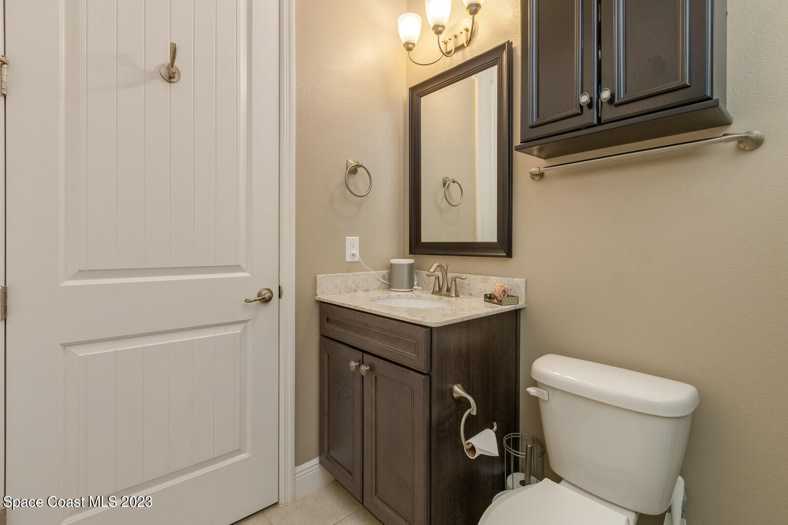 5107 Kirkwall Circle Melbourne, FL 32940 - Photo 39 of 44 a bathroom with a toilet sink and mirror