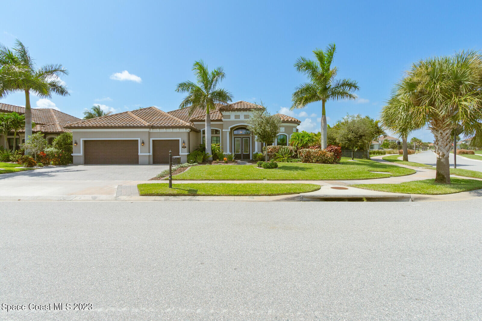 5107 Kirkwall Circle Melbourne, FL 32940 - Photo 43 of 44 a front view of a house with a yard and palm trees