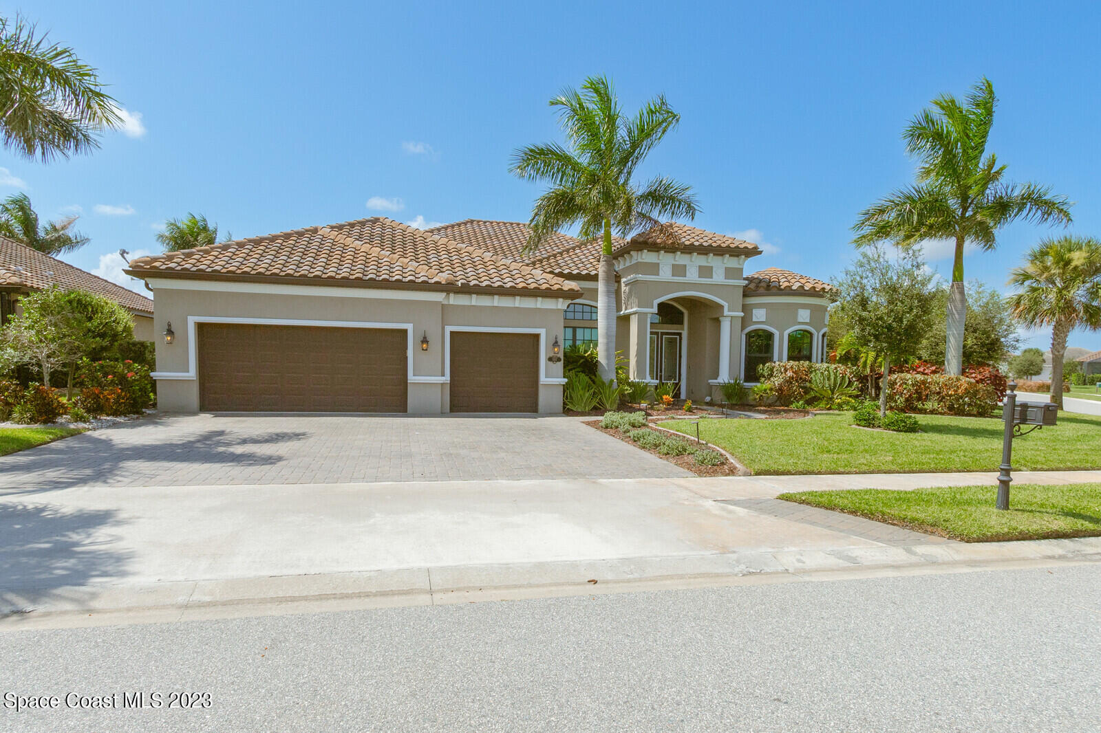 5107 Kirkwall Circle Melbourne, FL 32940 - Photo 44 of 44 a front view of a house with a garden and palm trees