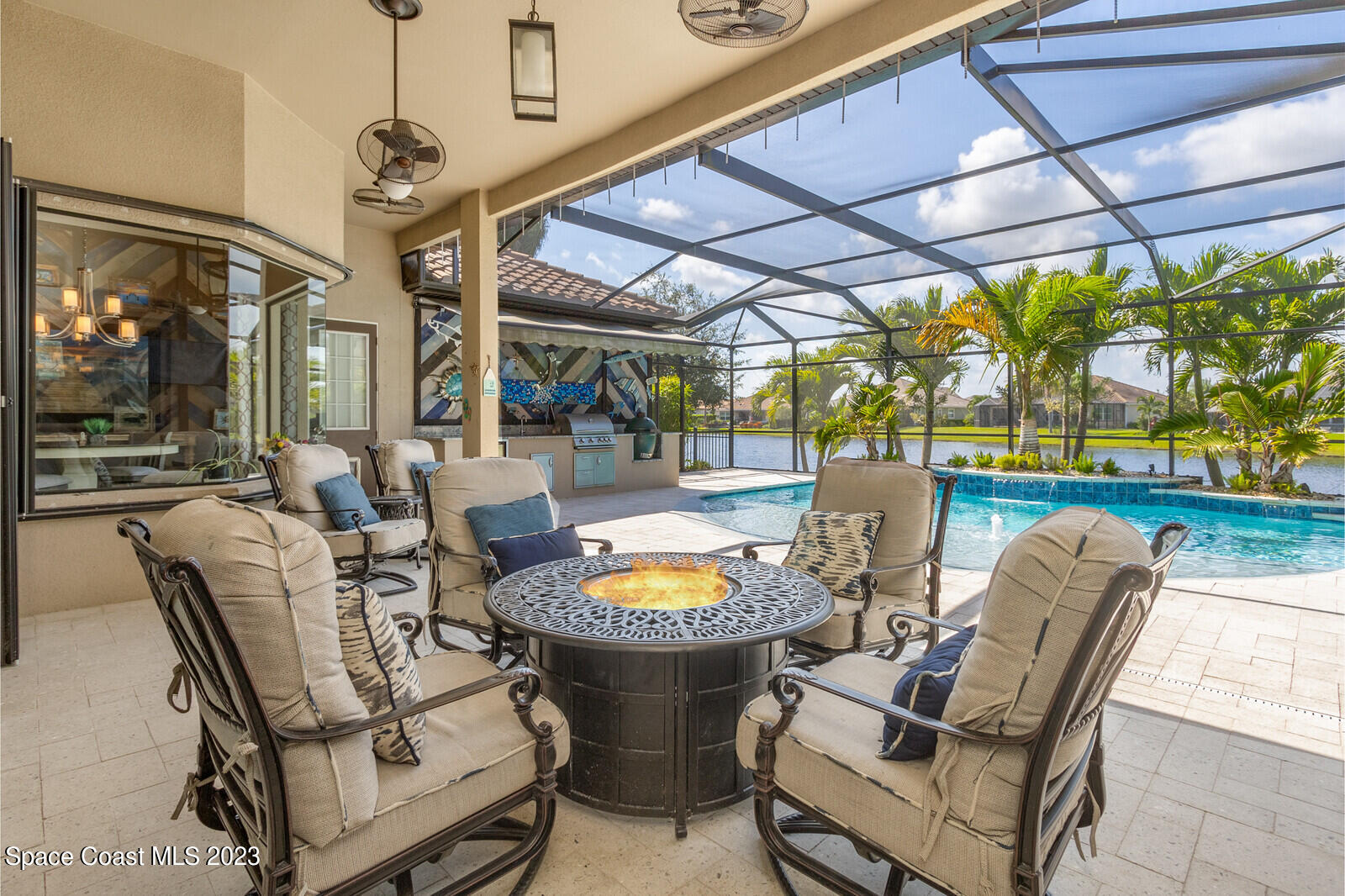 5107 Kirkwall Circle Melbourne, FL 32940 - Photo 7 of 44 a view of a swimming pool with a table and chairs