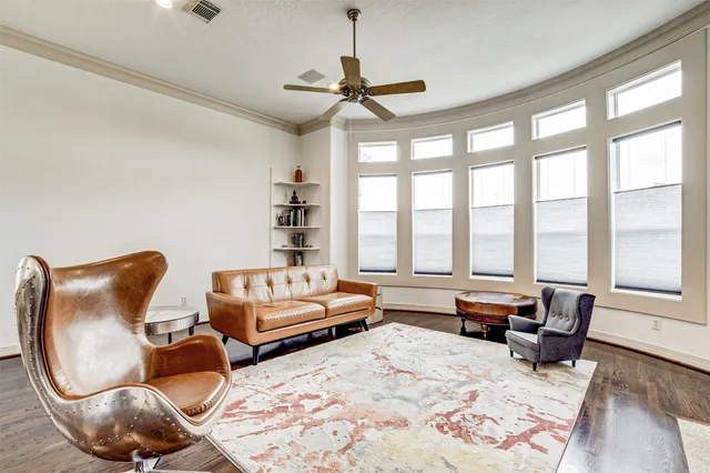 a living room with furniture and a floor to ceiling window