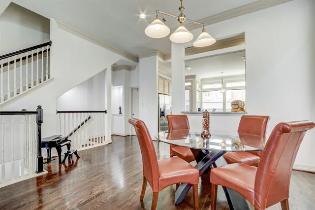 a view of a dining room with furniture a chandelier and wooden floor