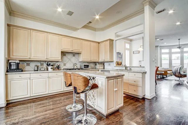 a kitchen with a sink cabinets and wooden floor