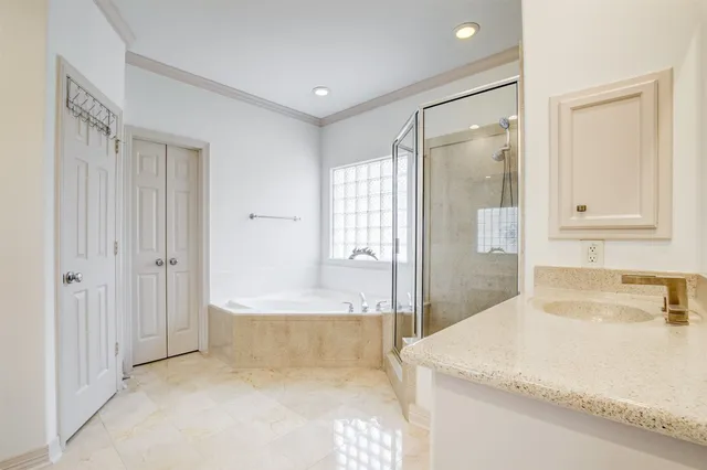 a bathroom with a tub shower and sink