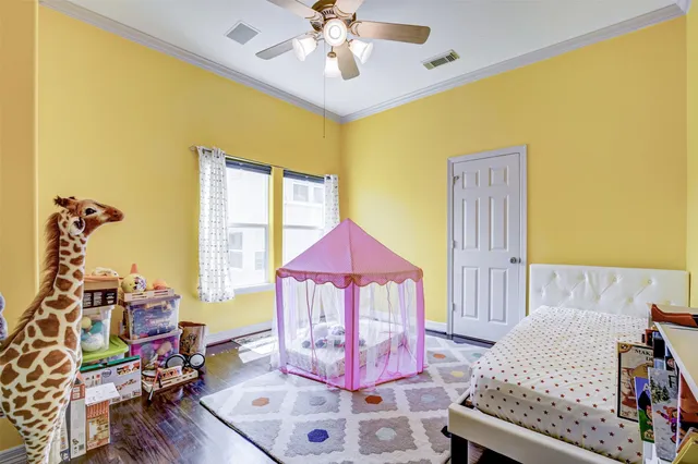 a bedroom with a bed and wooden floor