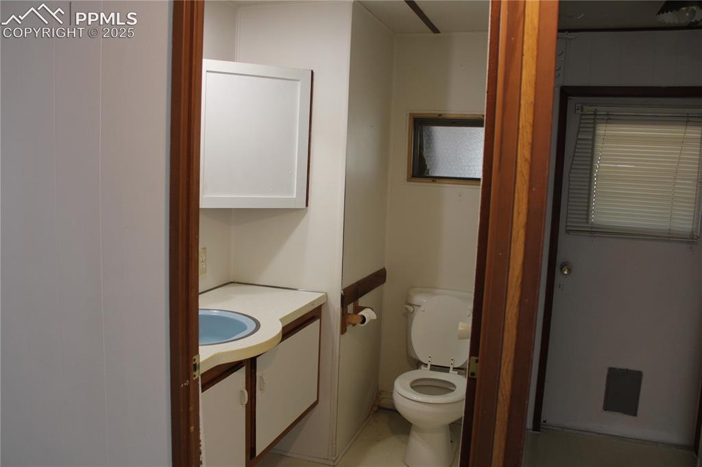 8320 Piute Road Colorado Springs, CO 80926 - Photo 12 of 20 a bathroom with a granite countertop toilet and a sink