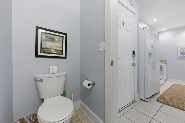 a white toilet sitting next to a bathroom sink