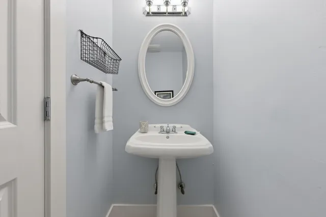 a bathroom with a sink a mirror and a toilet