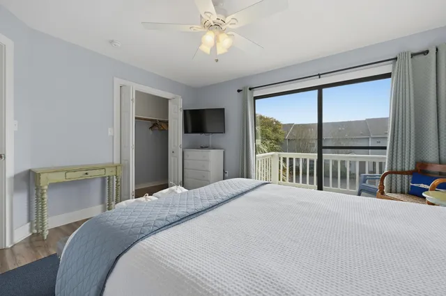 a bedroom with a large bed and a large window